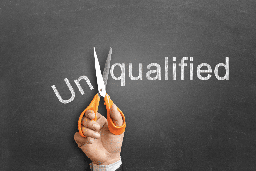 picture showing the word 'unqualified' and cutting it with scissors